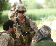April 23, 2012. A Marine of 2nd Battalion, 5th Marine Regiment, talks to locals in Musa Qa&rsquo;leh District, Afghanistan during a recent patrol. (Marine Cpl. Kenneth Jasik)