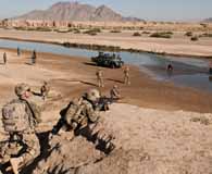 Soldiers of 1st Battalion, 64th Armor Regiment, Combined Task Force Arrowhead provide overwatch for Afghan Uniform Police as they lead a dismounted patrol in Dand district, southern Afghanistan, June 2, 2012. (Army Sgt. Matt Young)