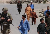 Sgt. Brian Baker, a medic with 101st Airborne Division, followed by a group of curious boys as he completes a patrol on June 25, 2012, in Marawara, Kunar Province. (Army Sgt. Andrea Merritt)